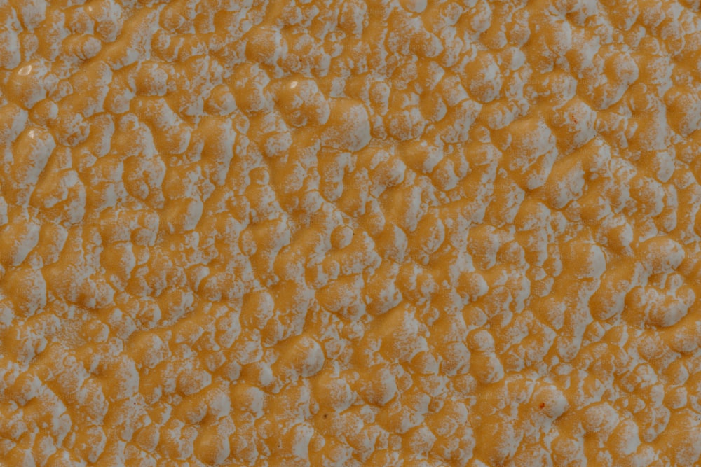 a close up of a yellow and white textured background