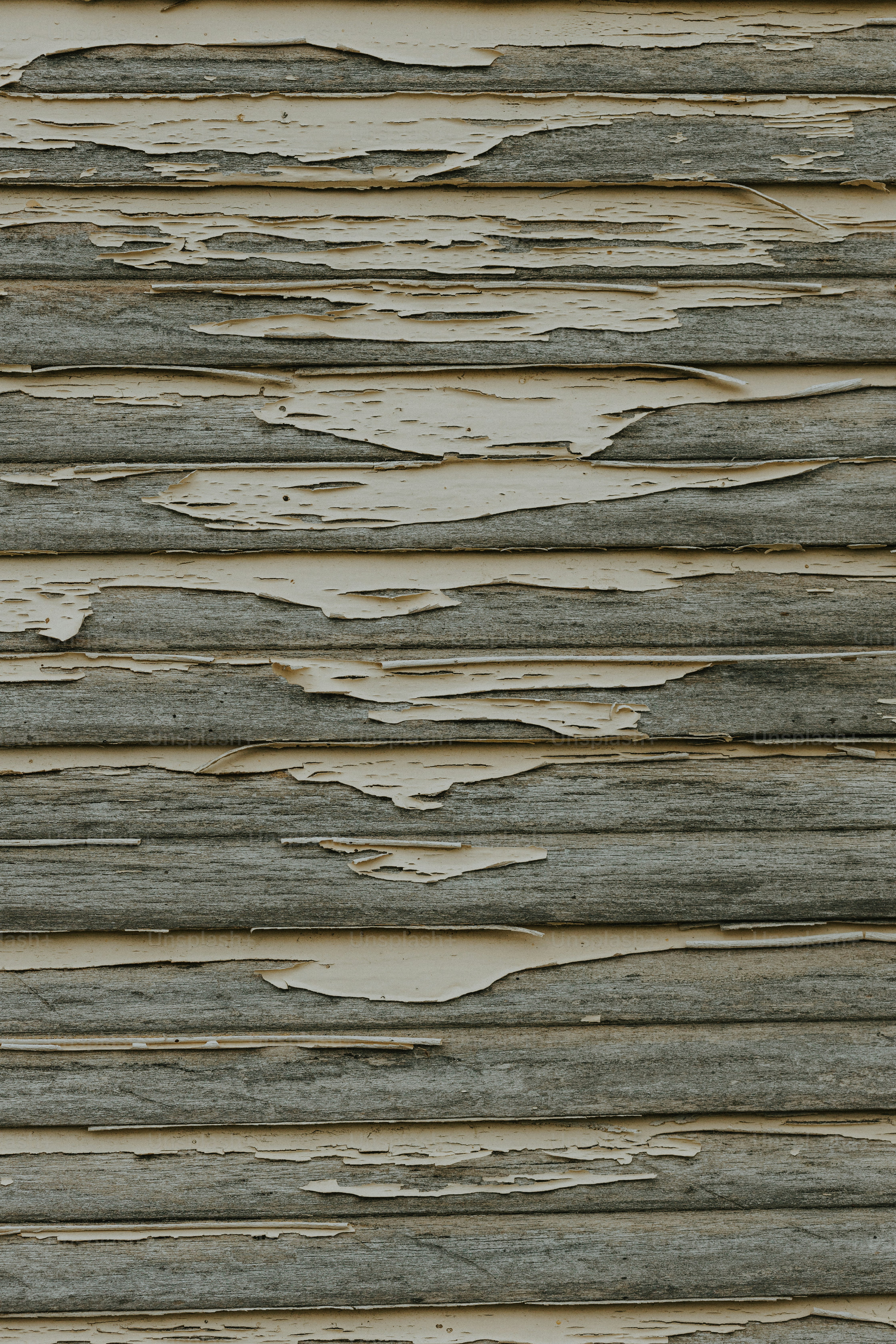 a close up of a wooden wall with peeling paint