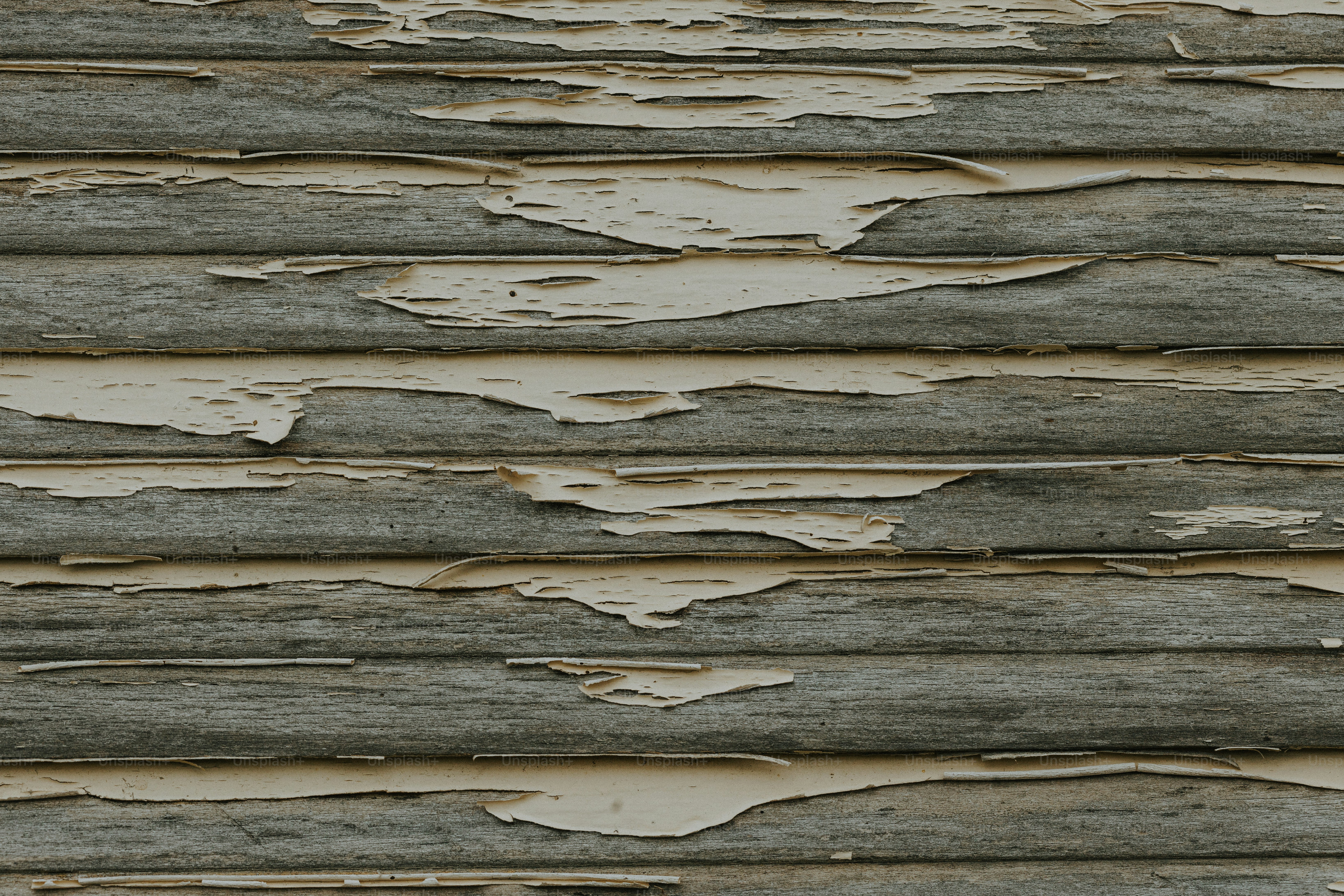 a close up of a wooden wall with peeling paint