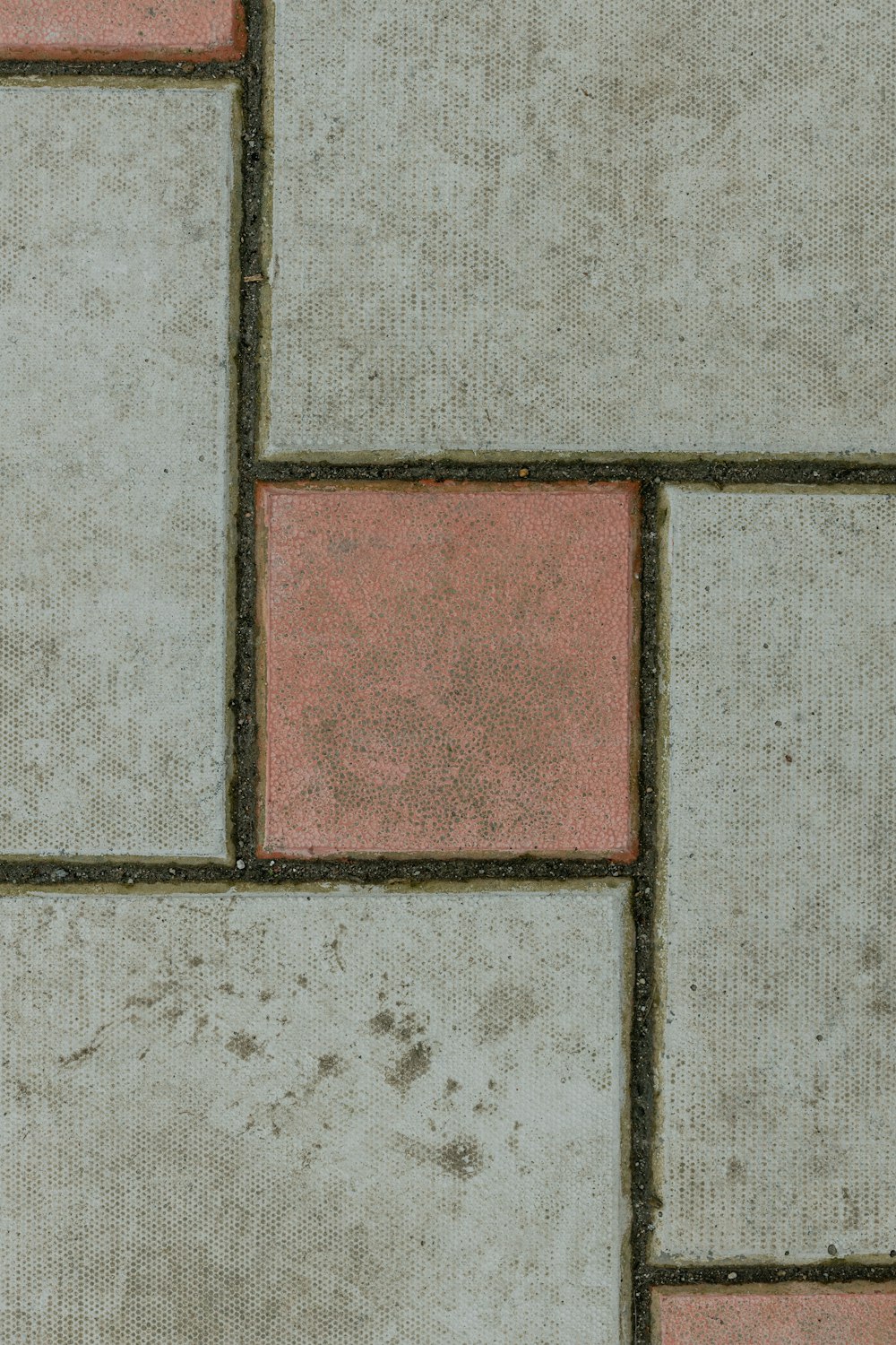 a close up of a red and white tiled floor