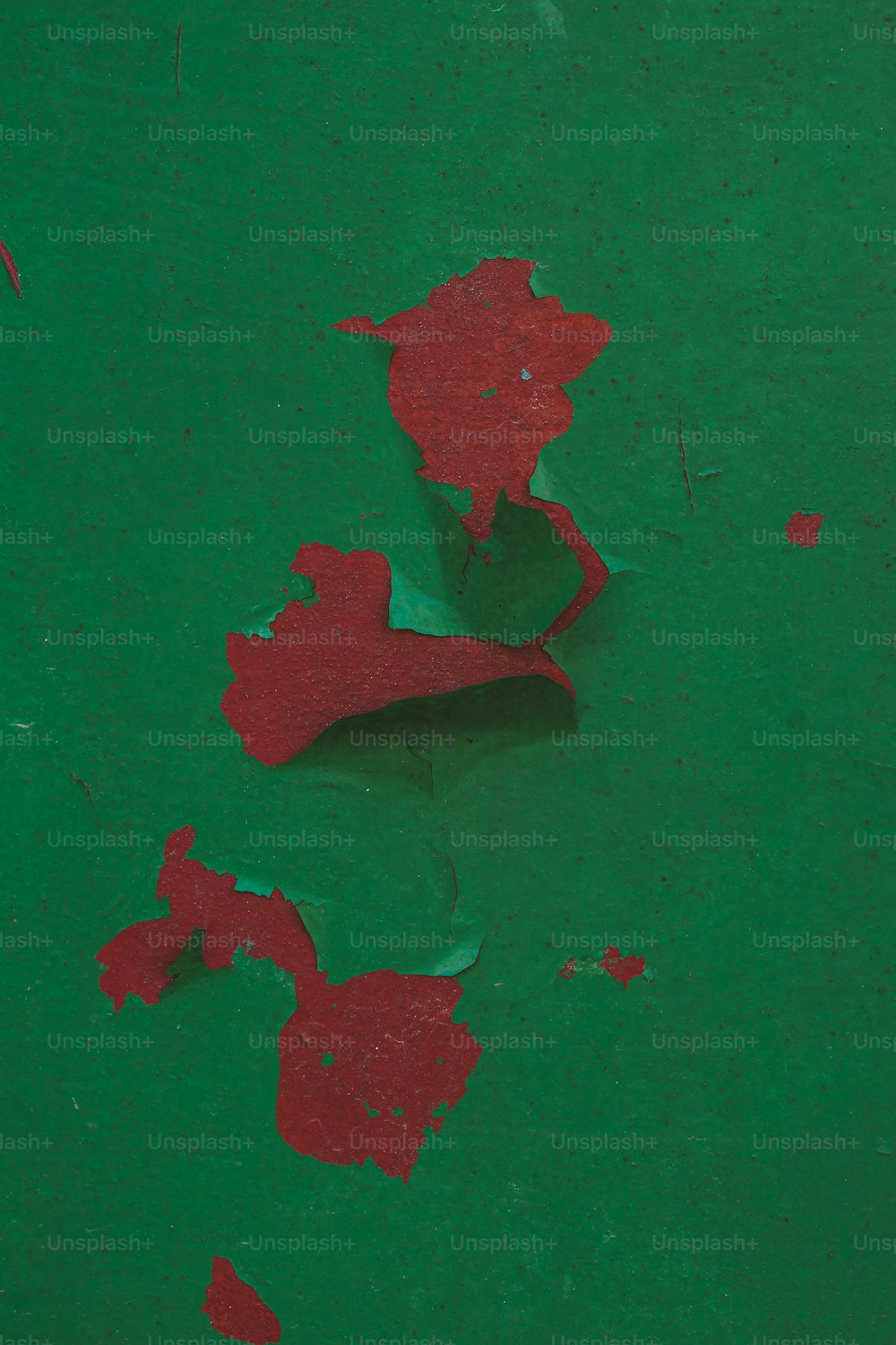 a red piece of paper on a green surface