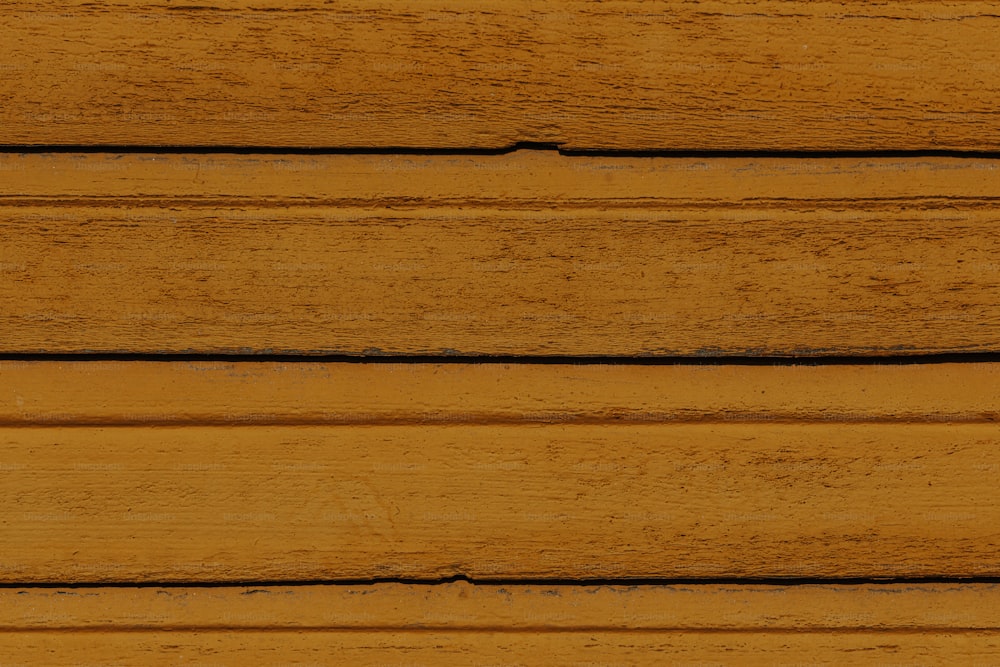 a close up of a wooden wall with a clock on it