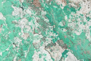a close up of a green and white marble