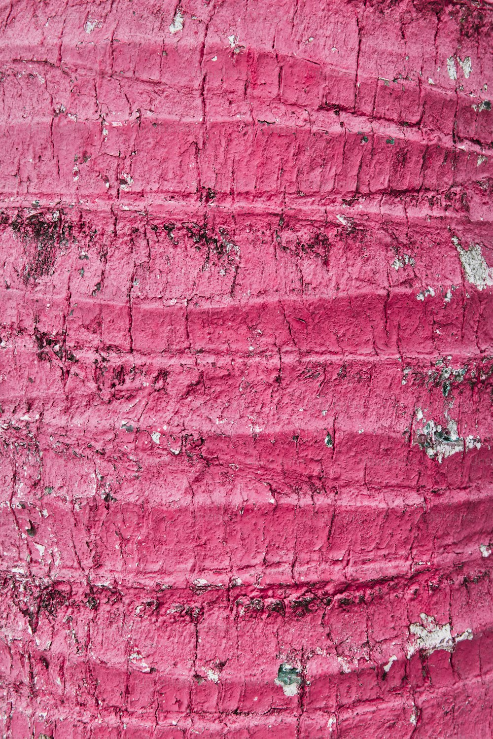 a close up of a pink painted wall