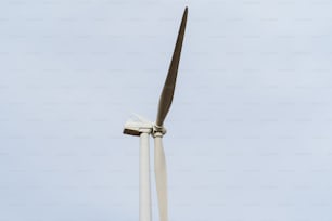 a close up of a wind turbine against a blue sky