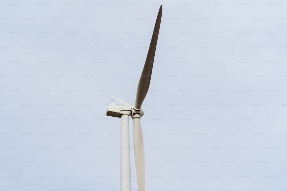 a close up of a wind turbine against a blue sky