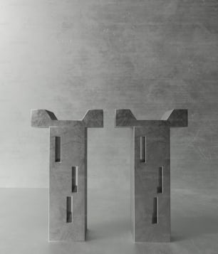 a couple of concrete sculptures sitting on top of a table