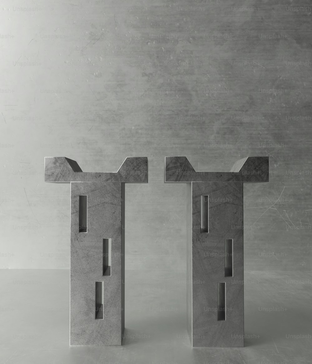 a couple of concrete sculptures sitting on top of a table