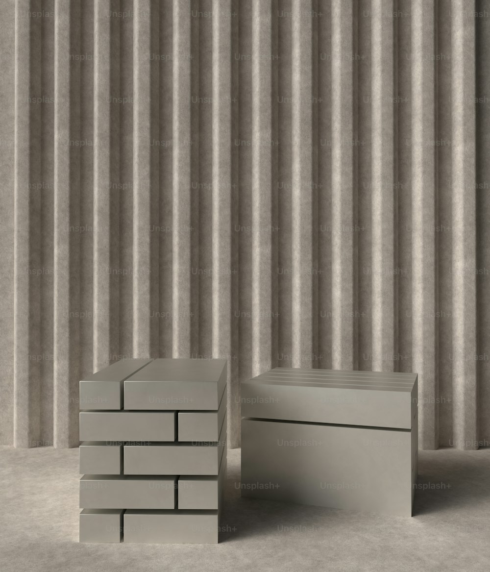 a stack of boxes sitting in front of a striped wall
