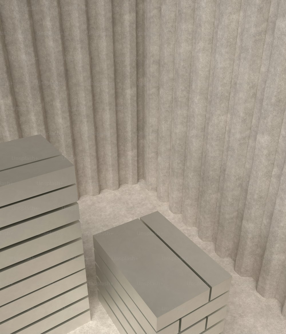 a stack of white boxes sitting next to a curtain