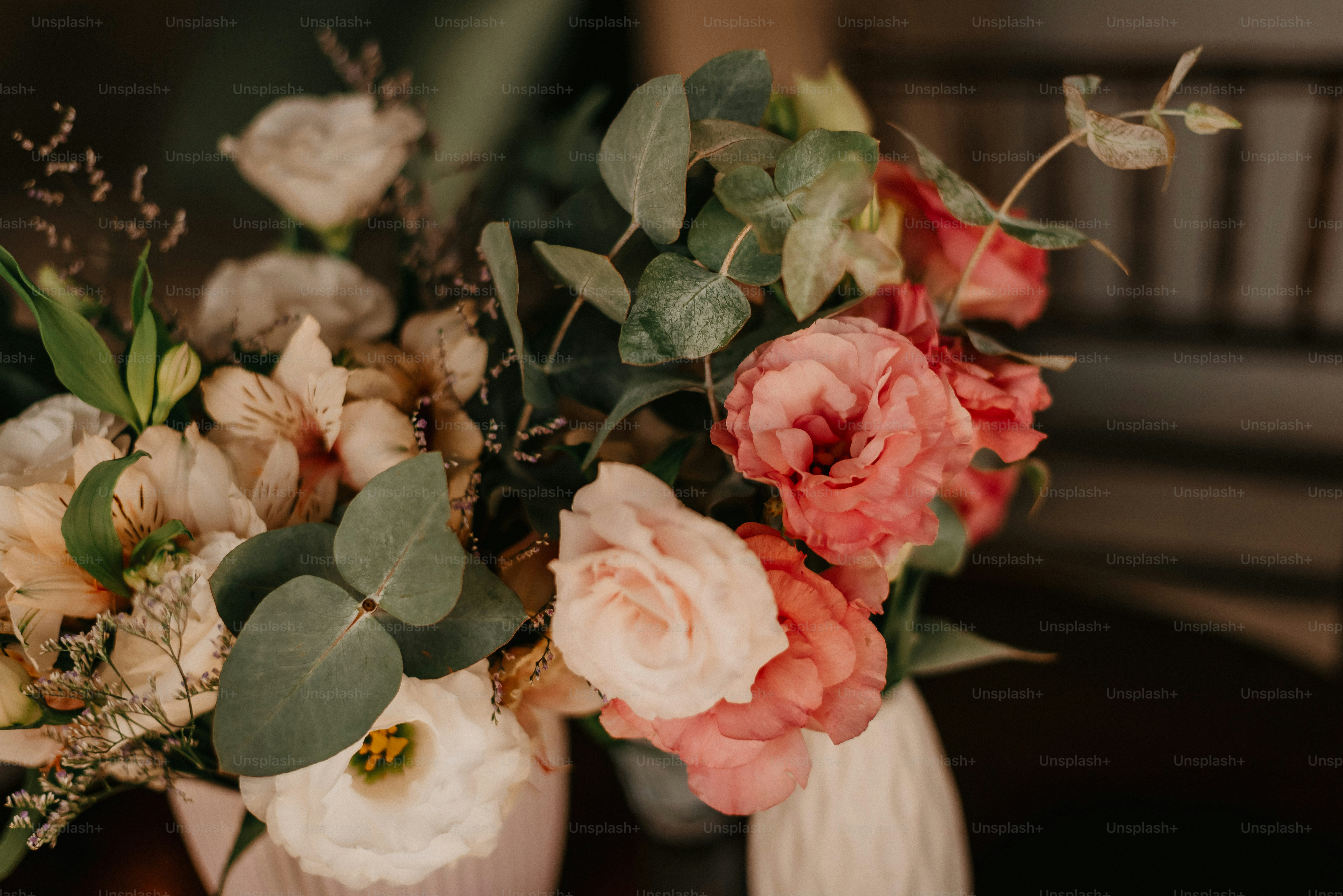 a couple of vases filled with different types of flowers