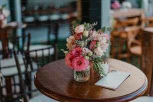 a wooden table with a vase of flowers on top of it