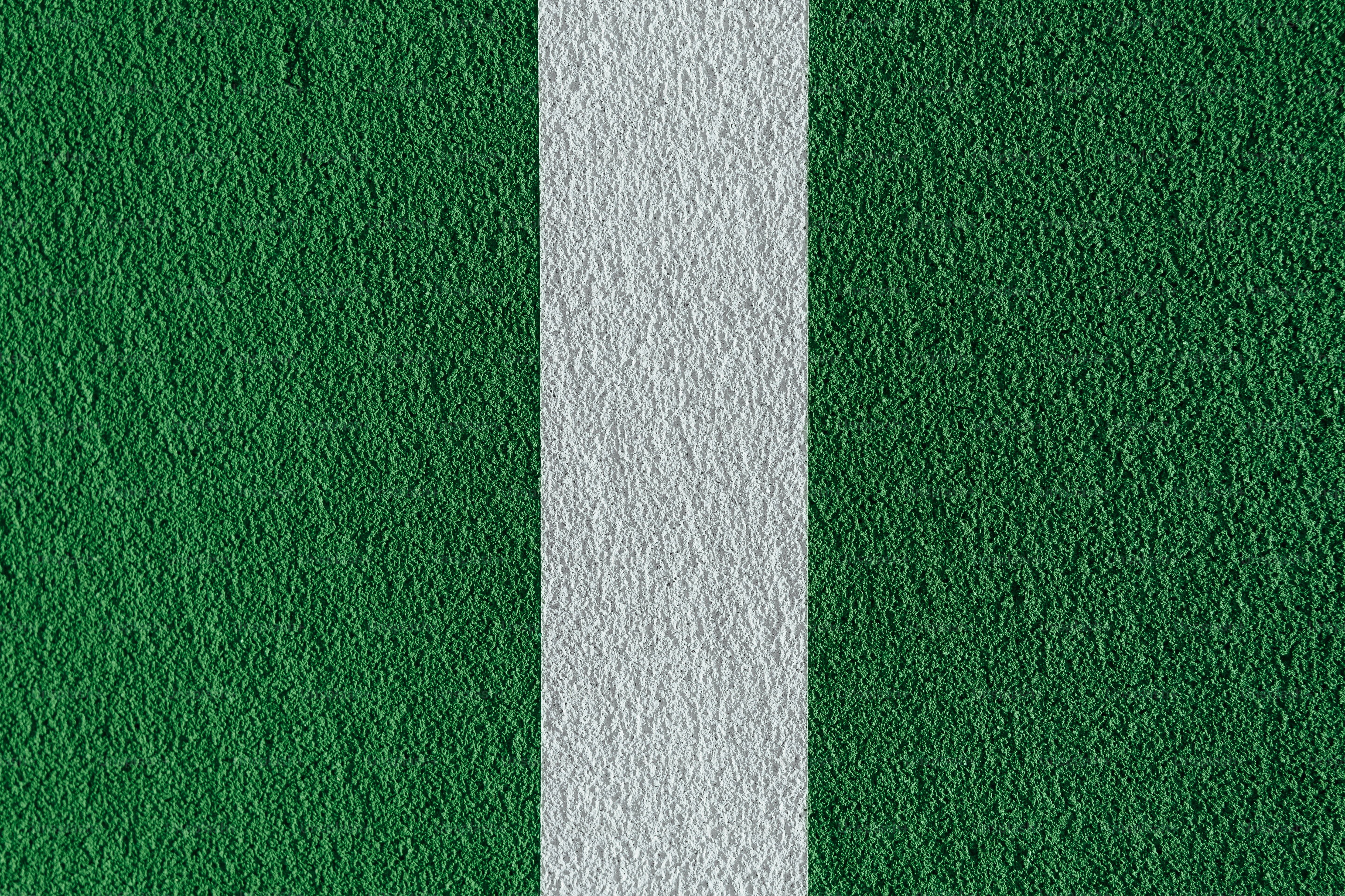 a close up of a white line on a green wall