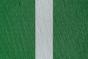 a close up of a white line on a green wall