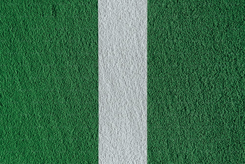 a close up of a white line on a green wall