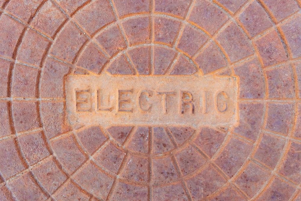 a close up of a street sign on a brick surface