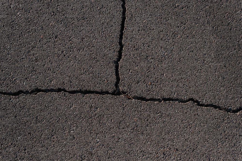 a close up of a crack in the asphalt