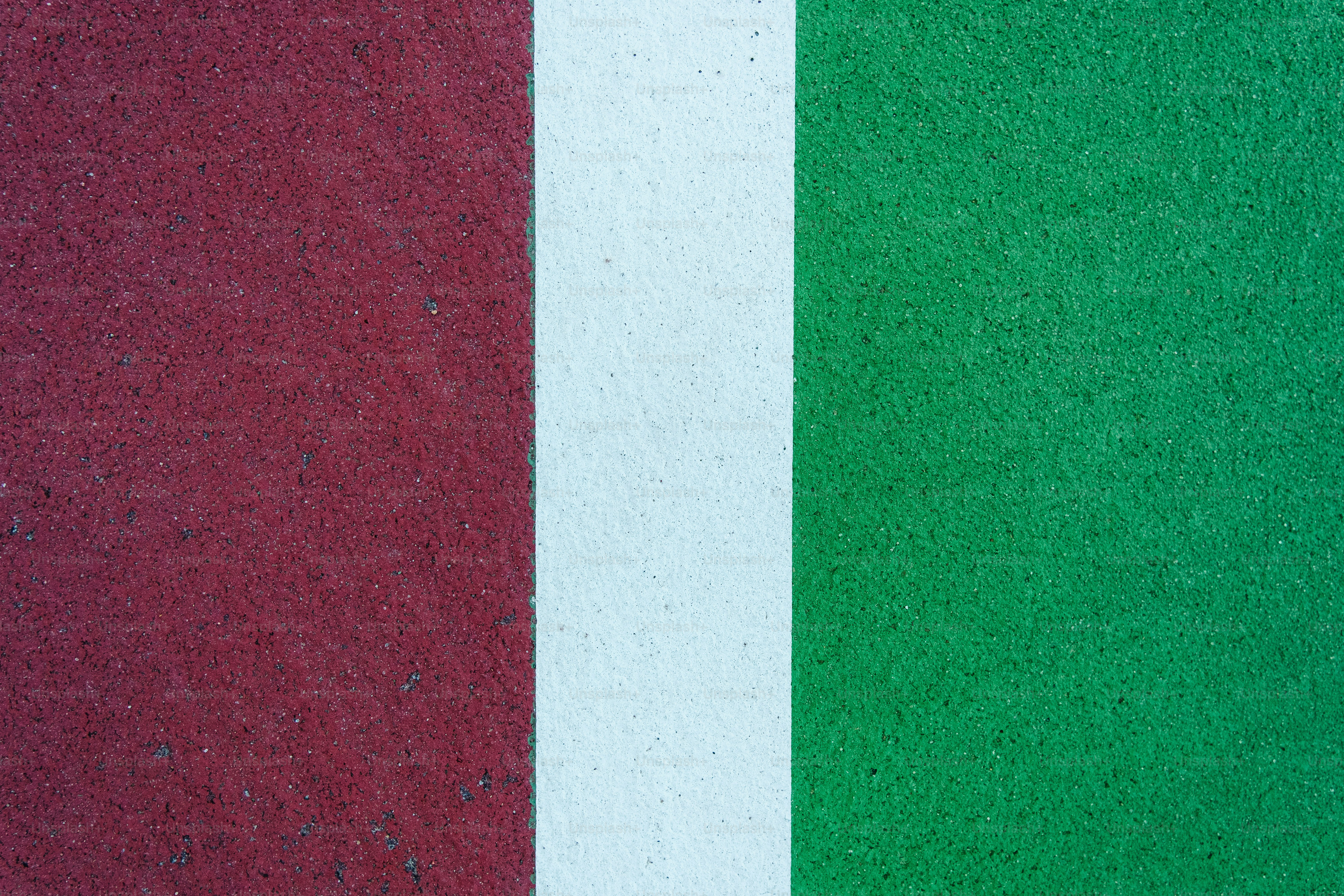 a close up of a red, white and green wall
