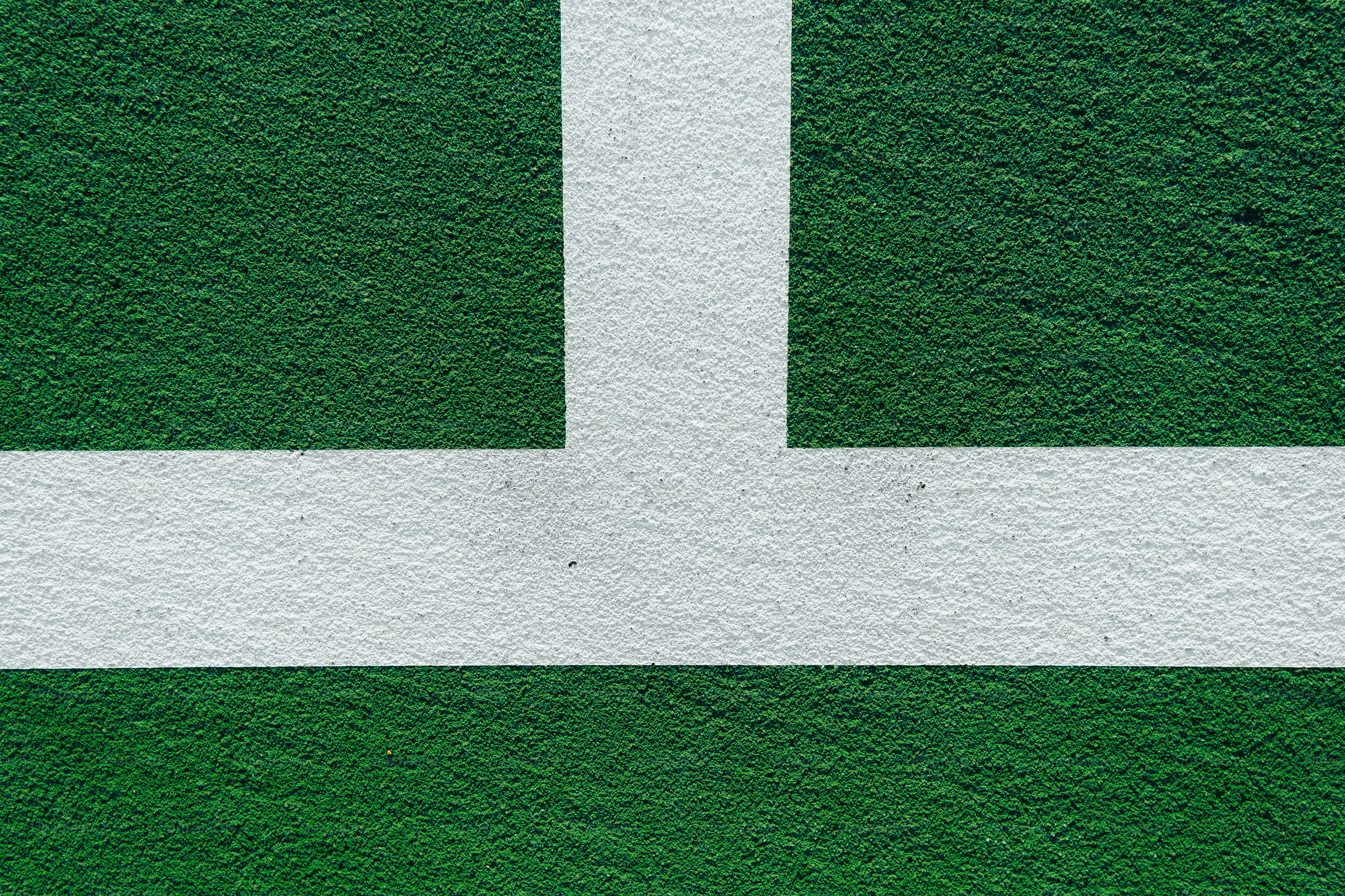 a green and white wall with a white arrow painted on it