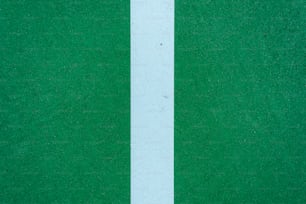 a close up of a white line on a green surface