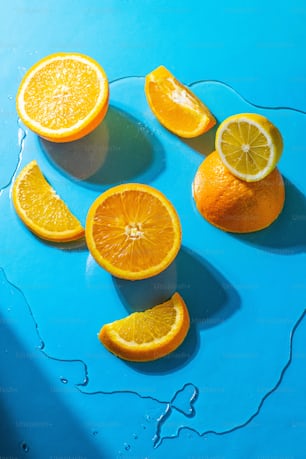a group of oranges sitting on top of a blue table