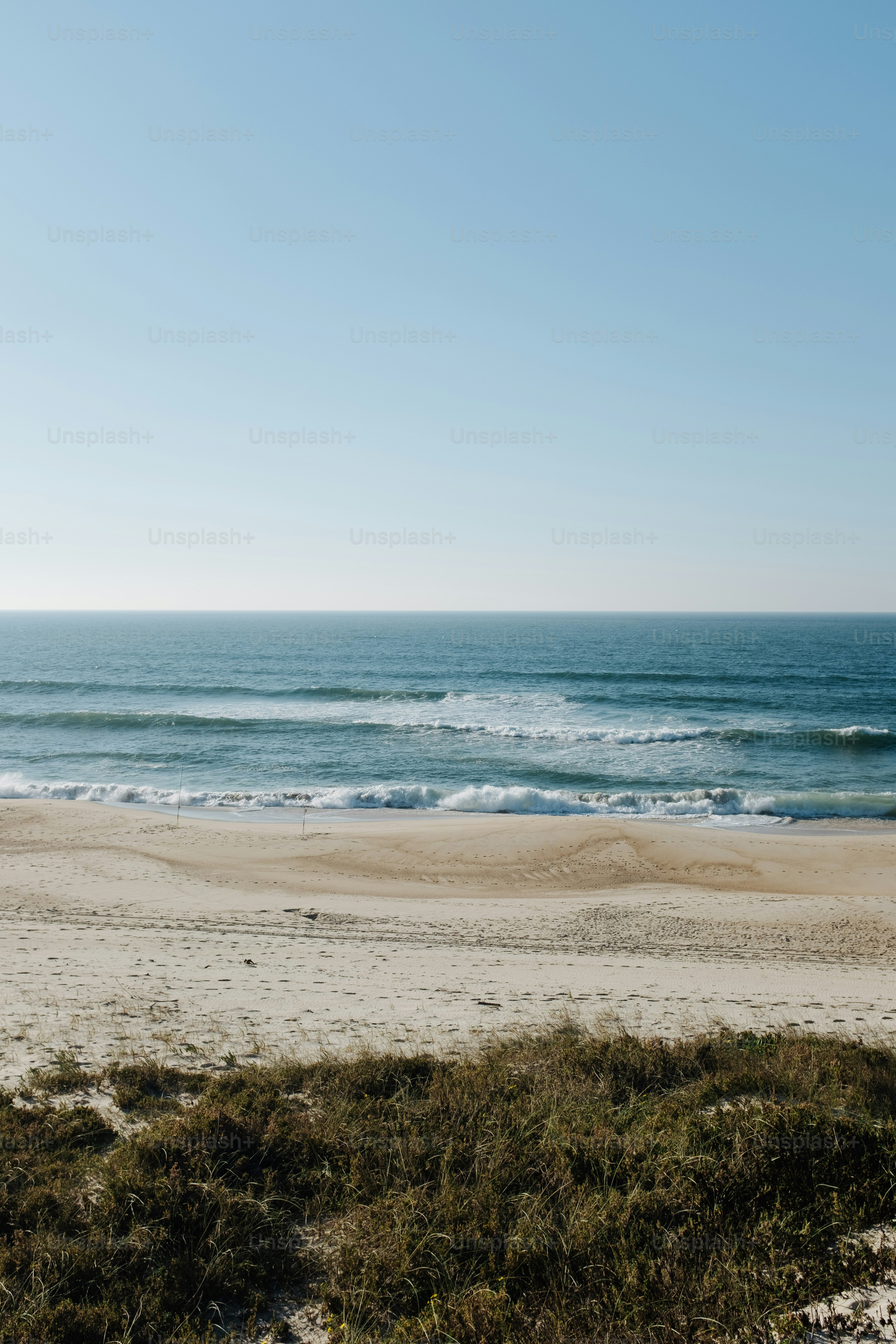 a view of the ocean from a sandy beach