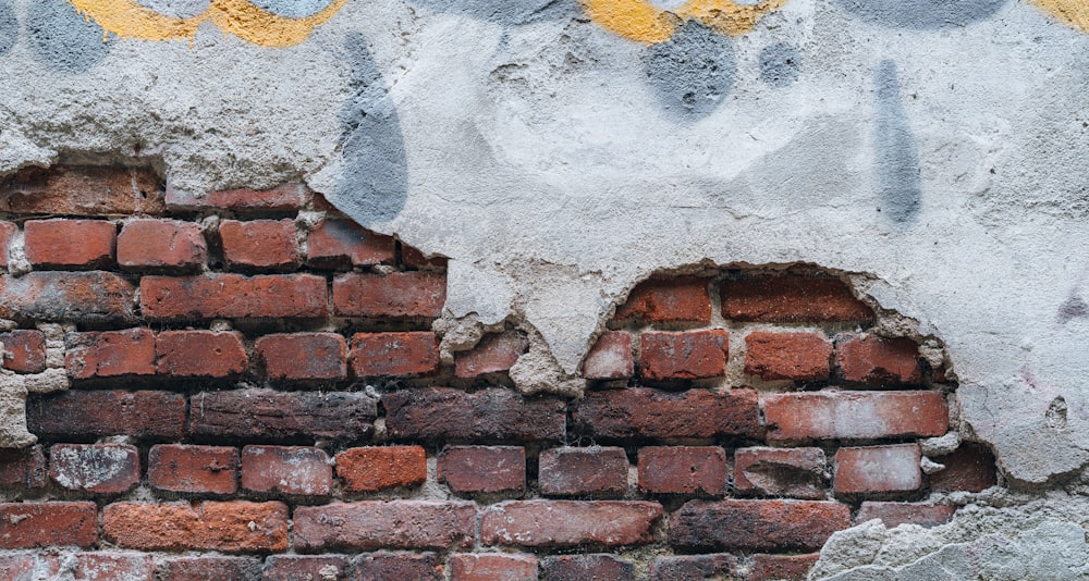 a brick wall with graffiti on it