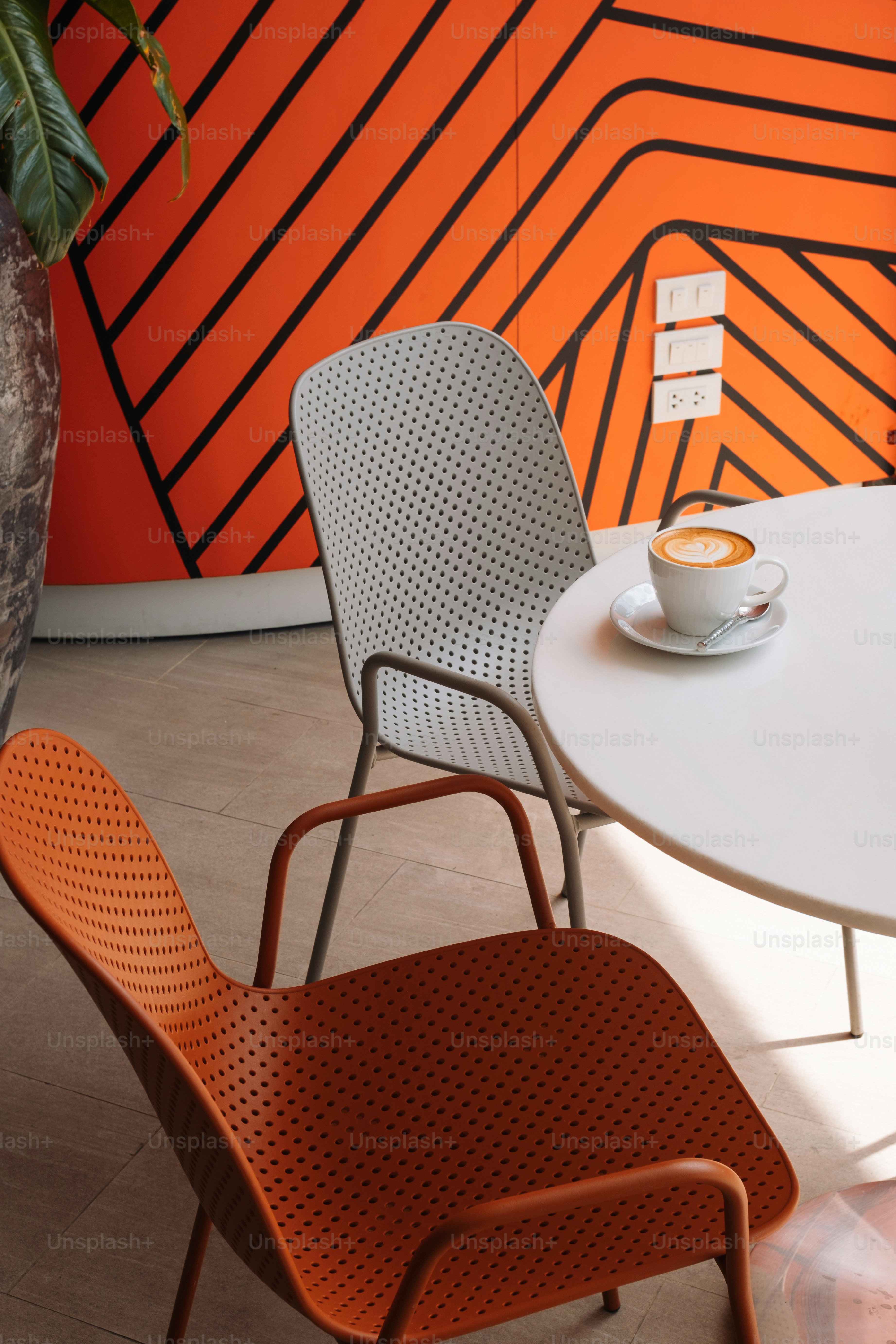 a white table with a cup of coffee on top of it