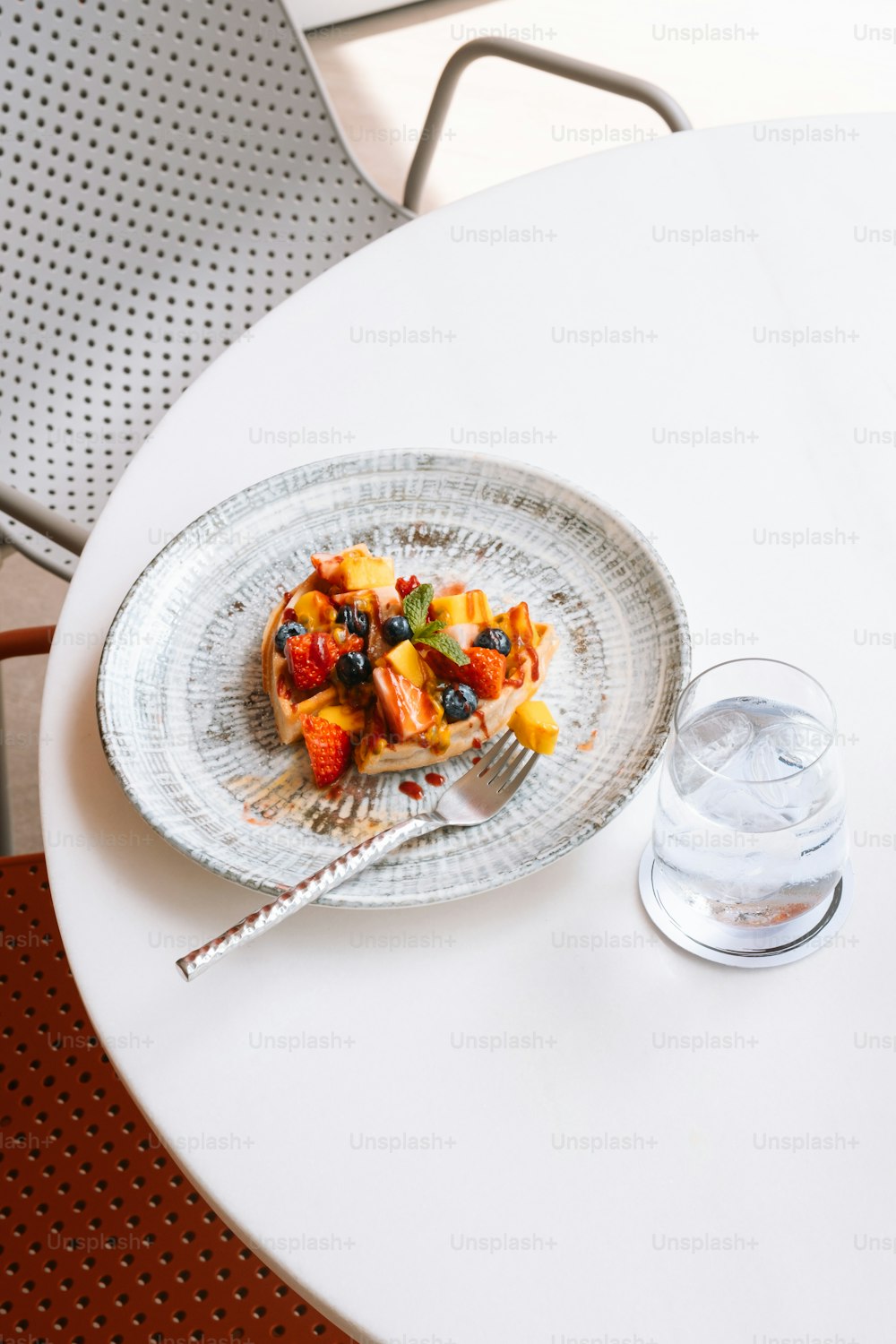 a plate of food on a table with a glass of water