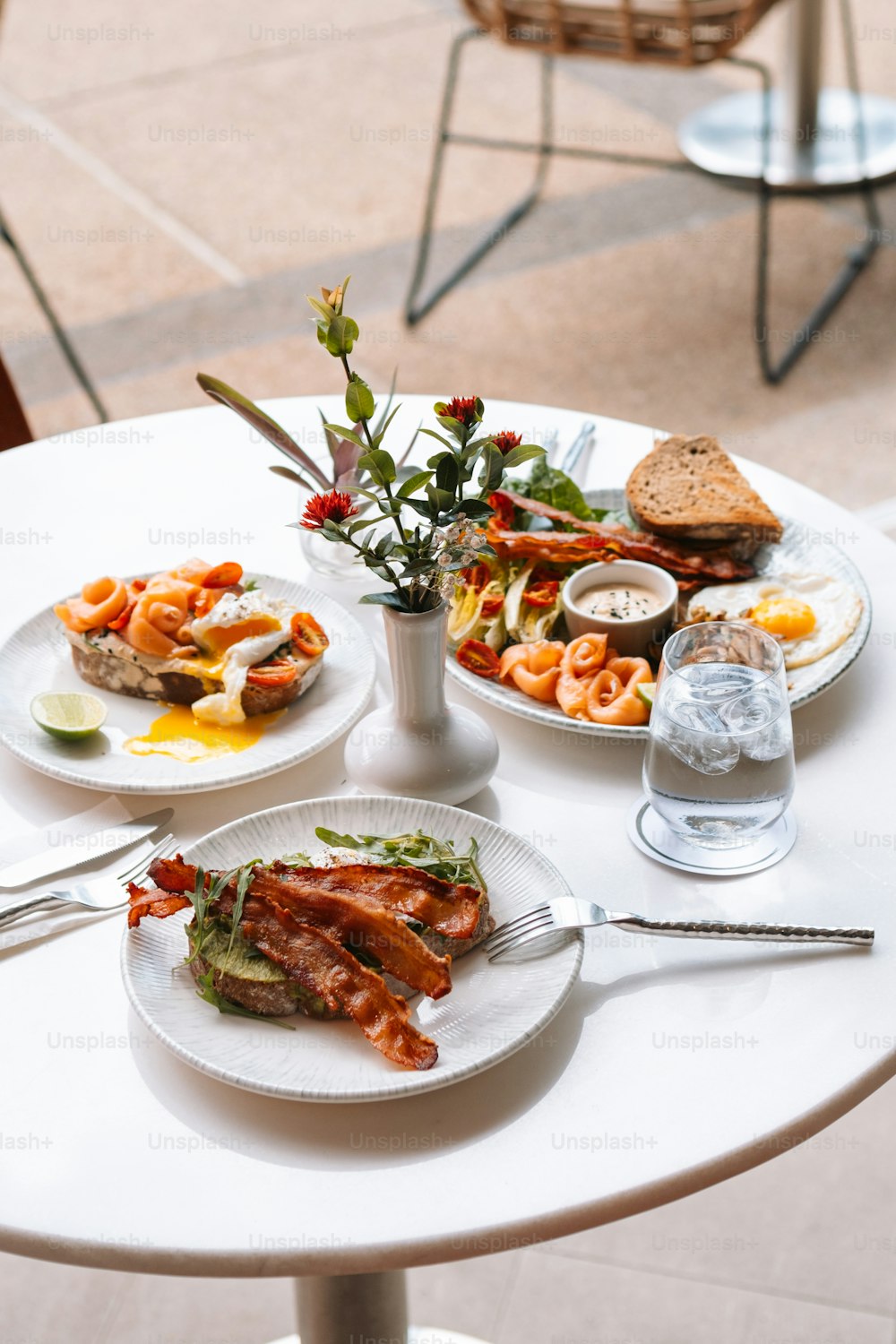 a white table topped with plates of food