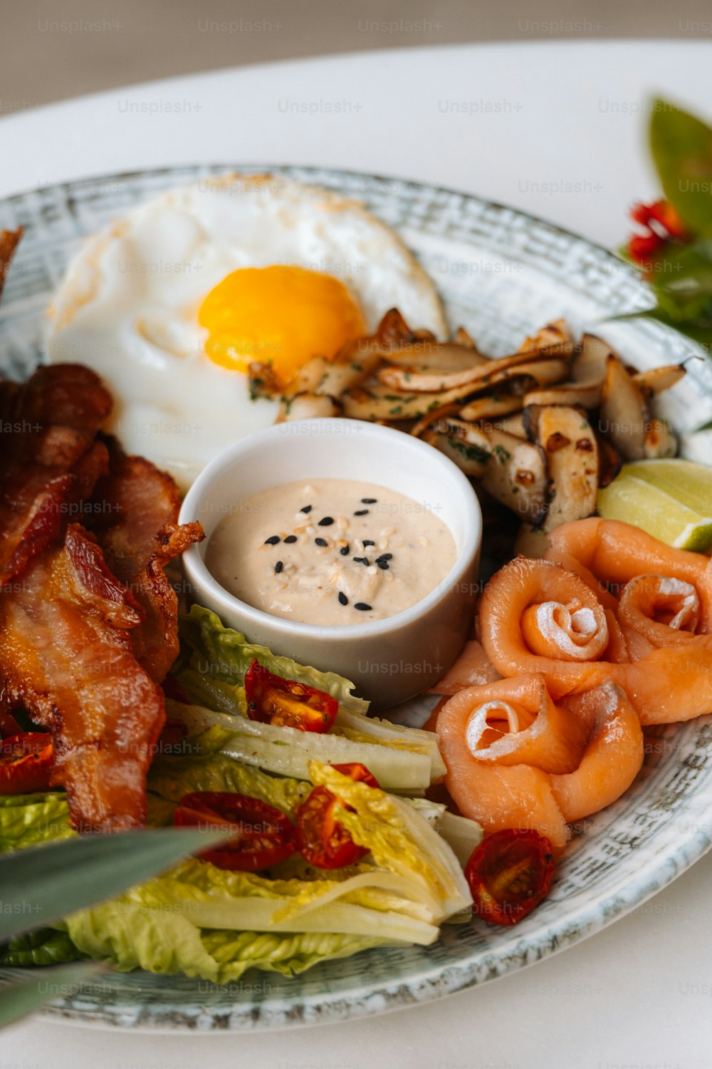 a white plate topped with bacon, lettuce and eggs