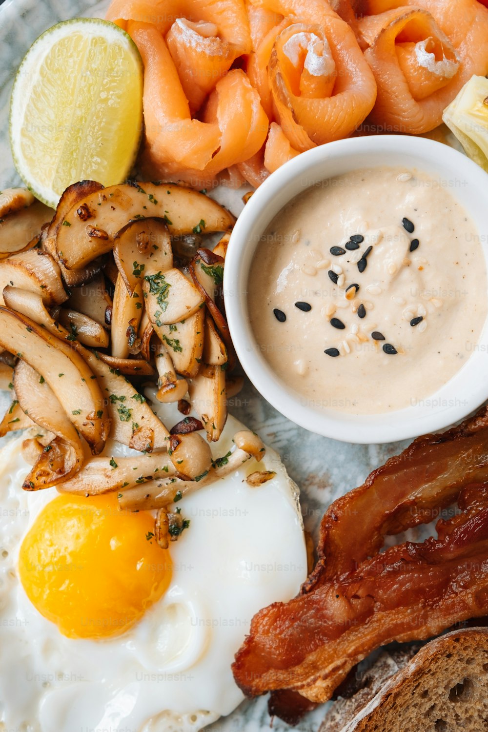 a plate of food with eggs, bacon, and carrots