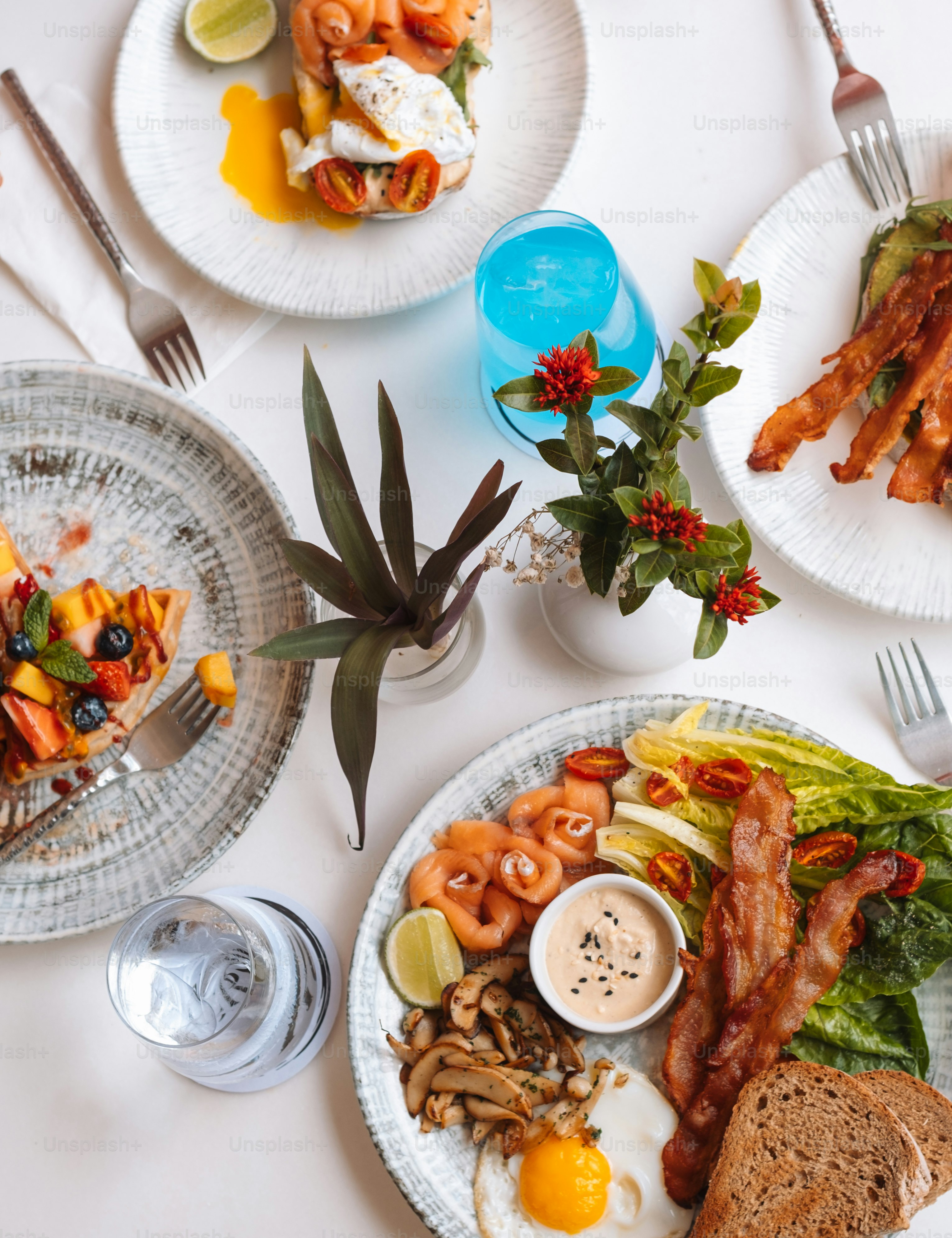 a white table topped with plates of food