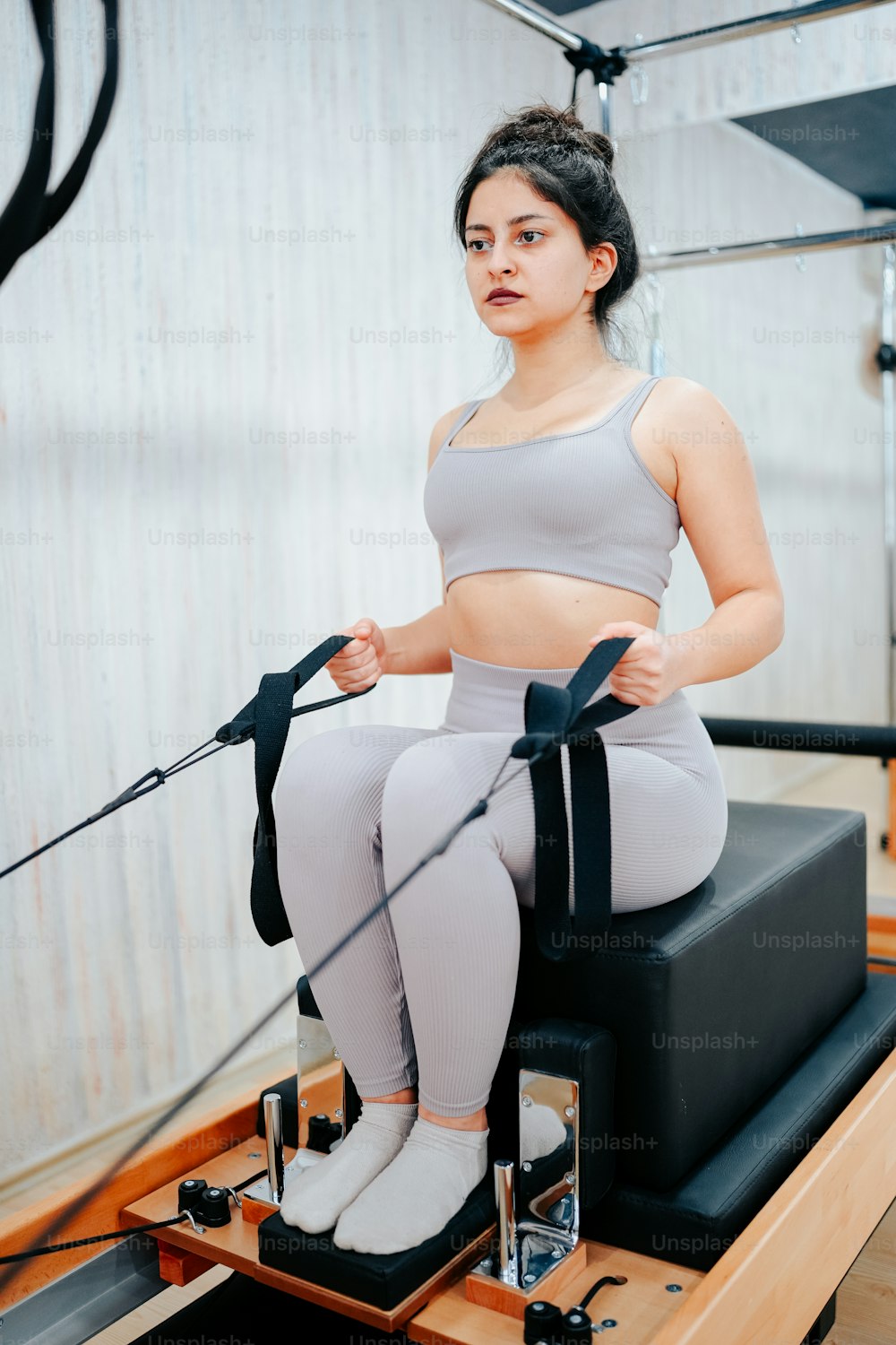 a woman is sitting on a rowing machine
