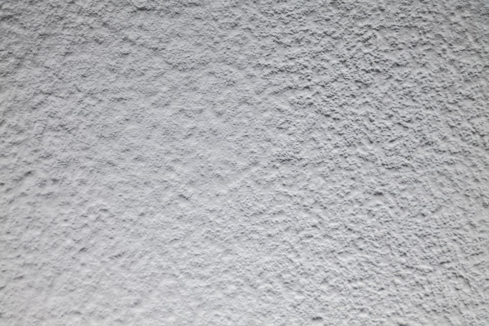 a close up of a white stucco wall