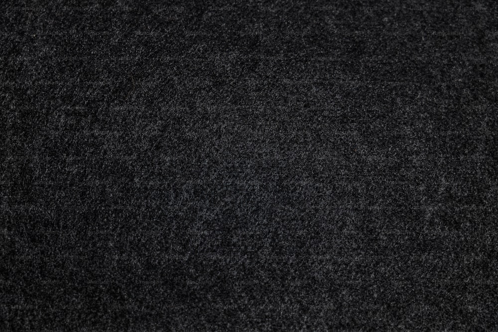 a close up view of a black carpet