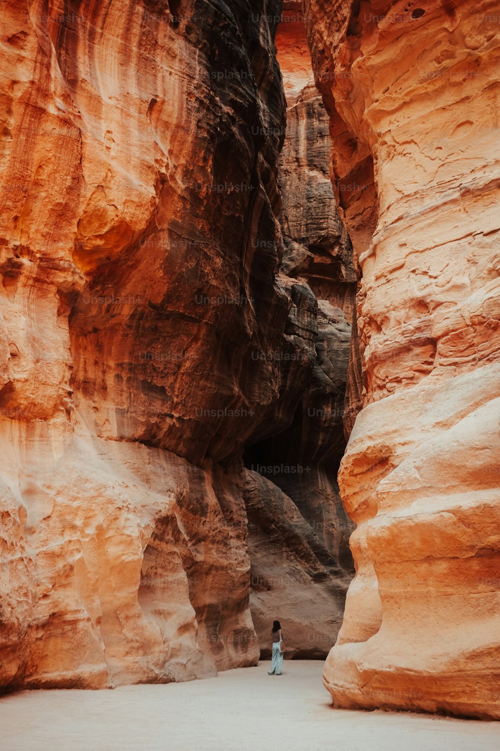 a person standing in the middle of a canyon