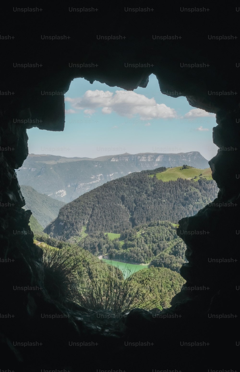 a view of a valley through a cave