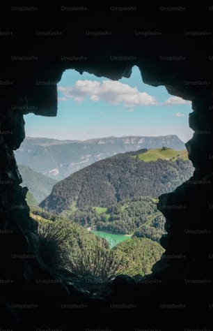 a view of a valley through a cave