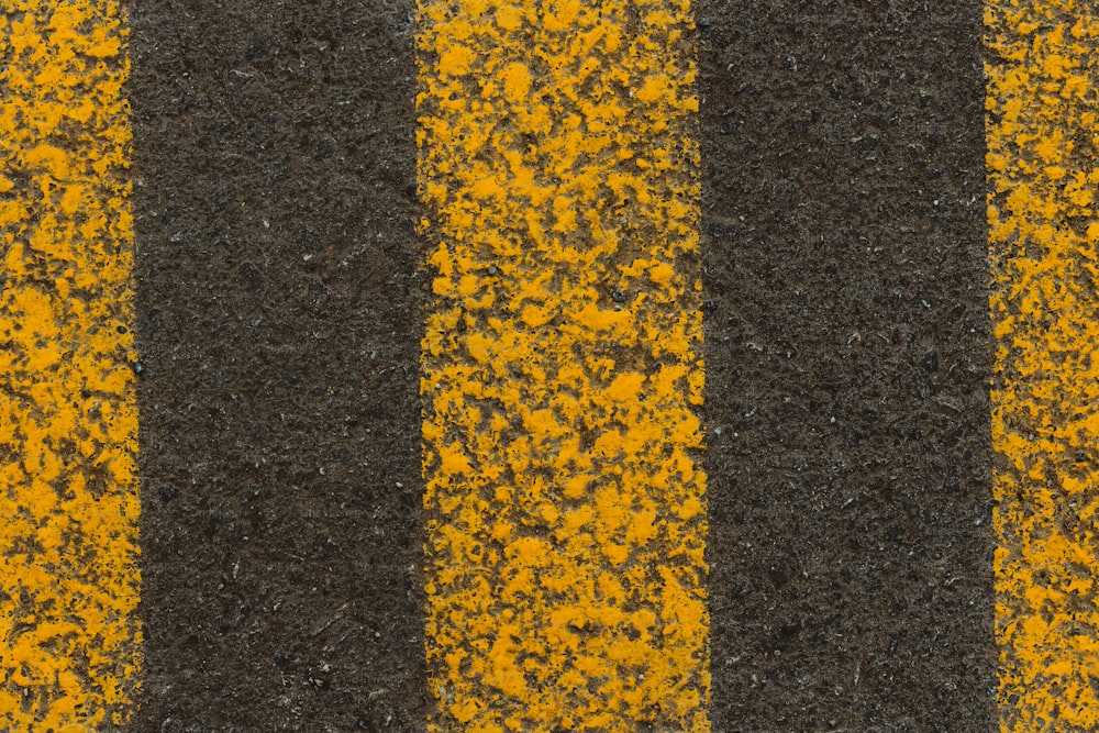 a close up of a yellow and black striped road