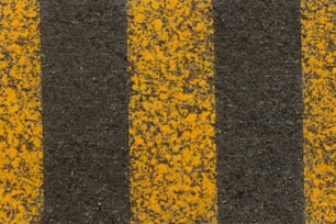 a close up of a yellow and black striped road