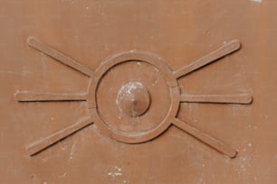 a close up of a brown wall with a circular design