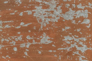 a brown and white wall with white paint on it