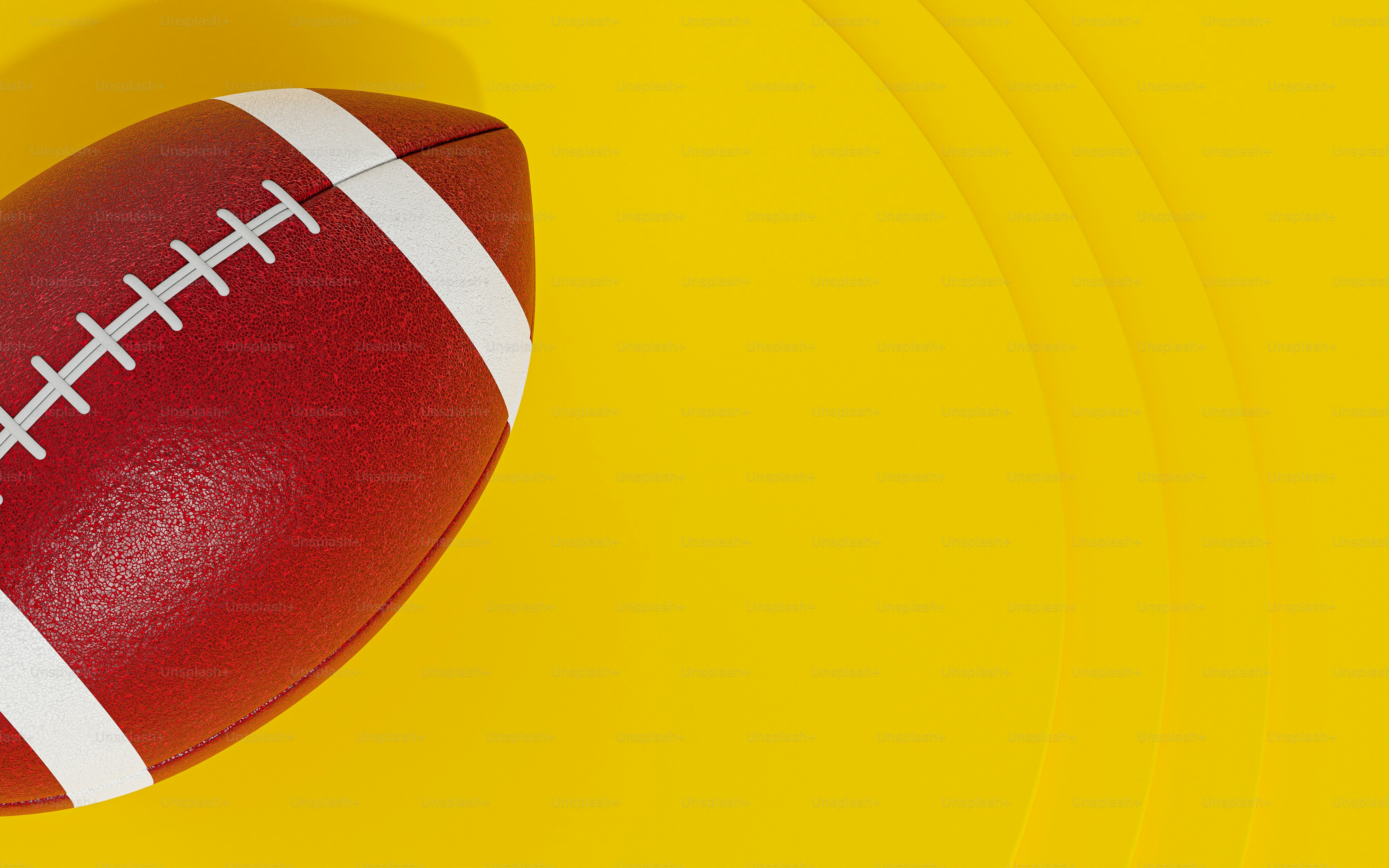 a close up of a football on a yellow background