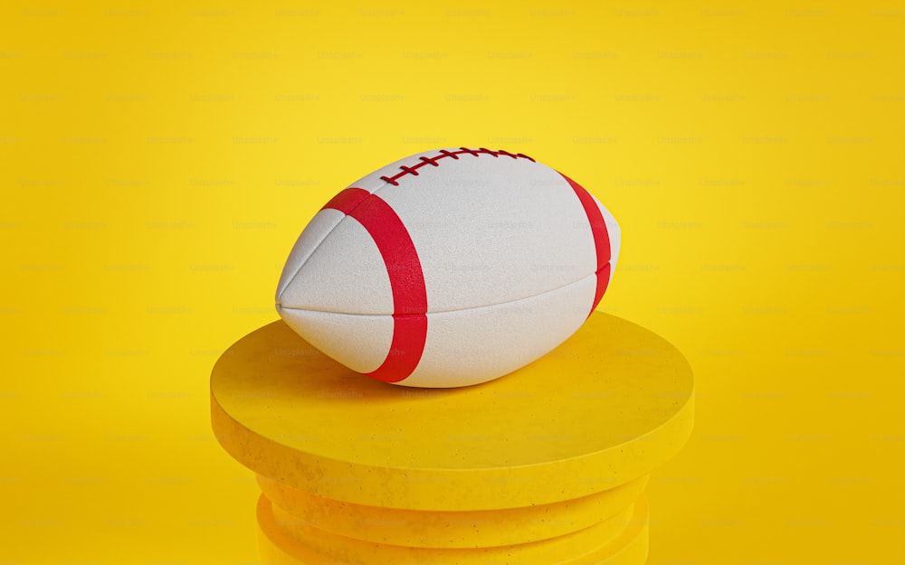 a white and red football sitting on top of a stack of yellow discs