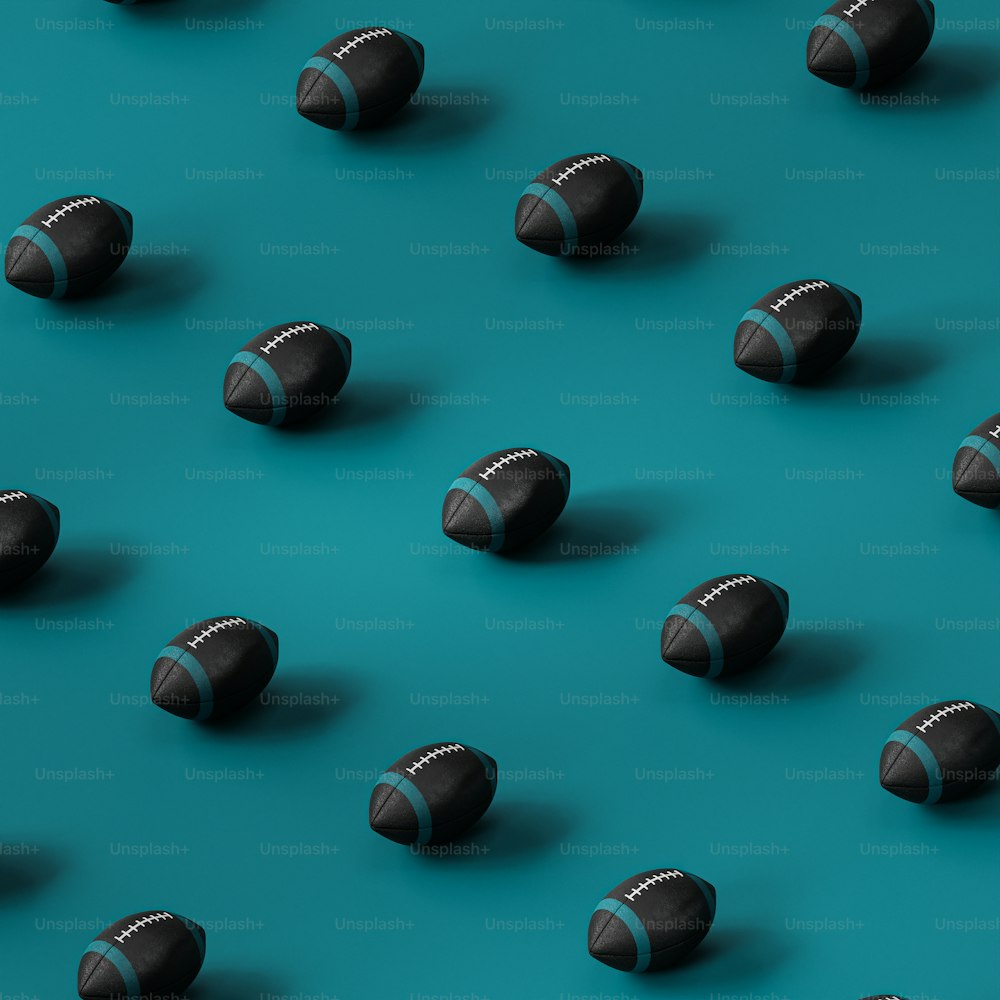 a group of black and silver balls on a blue surface