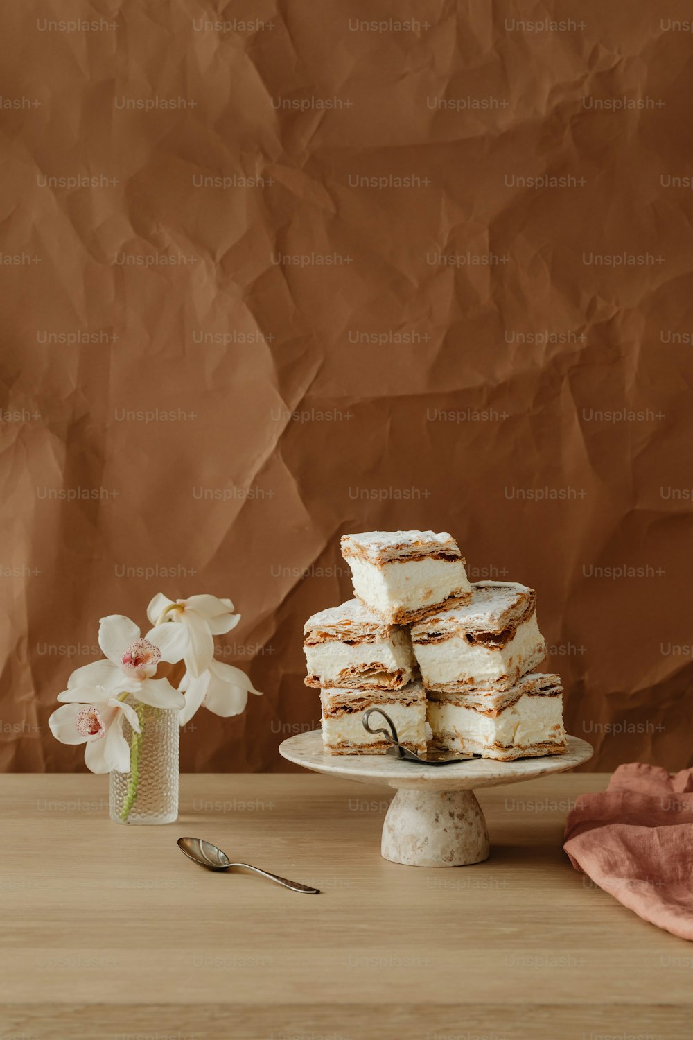 a stack of cake sitting on top of a wooden table