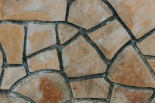 a close up of a clock on a stone wall