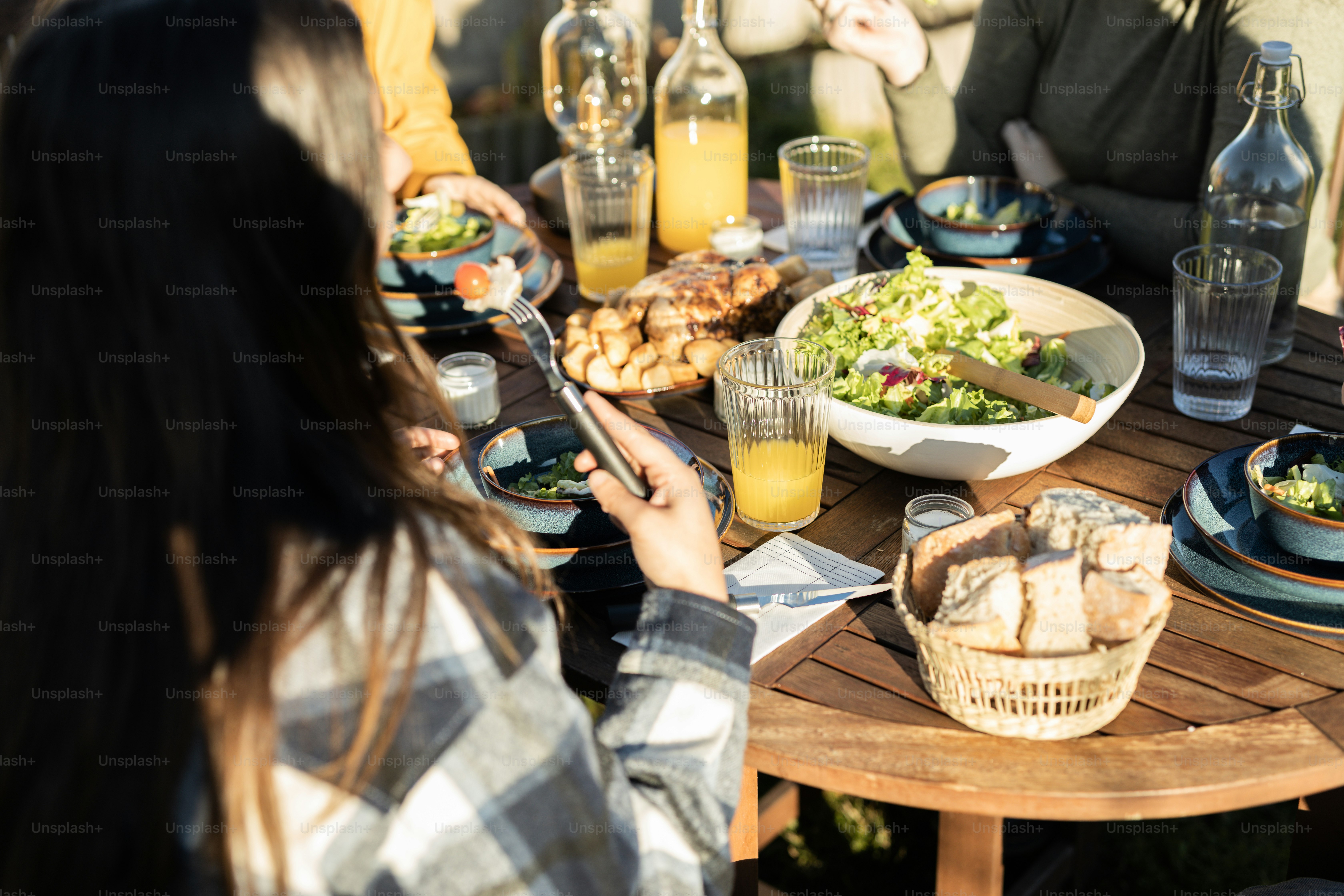 a group of people sitting around a table eating food