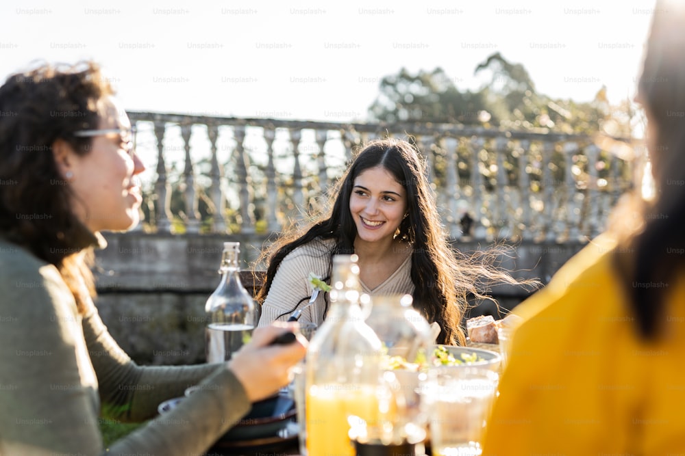 a group of women sitting around a table with drinks